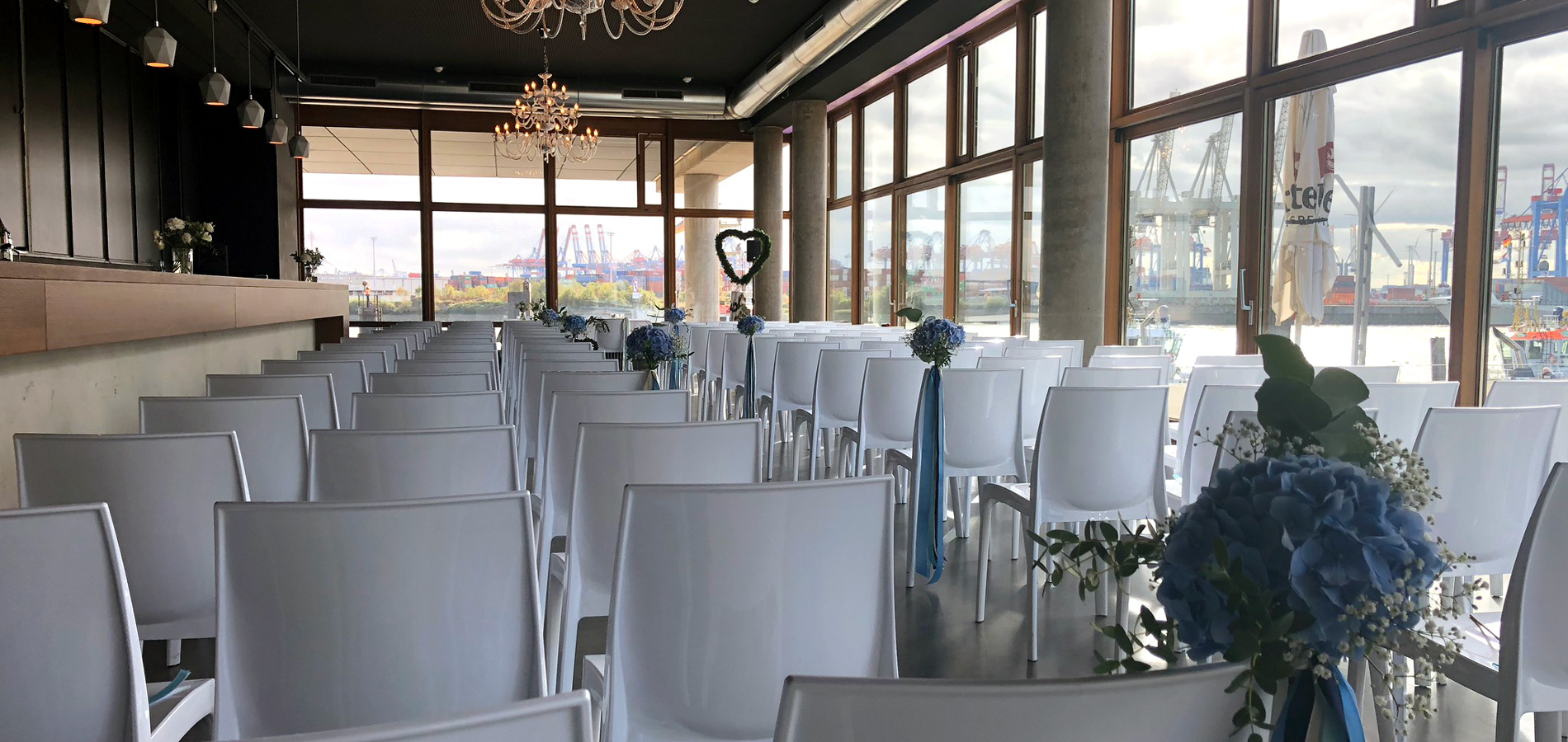 Eventlocation in Hamburg von NORD EVENT - View Eleven - Trauung mit Stuhlreihen am Tag mit Blick auf den Hafen